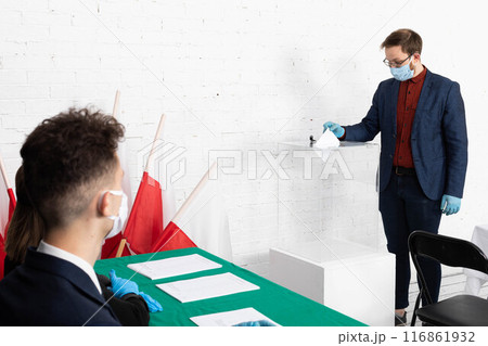 The young voter throws into the ballot box his votes for the new candidate for the new president of Poland. The young voter throws into the ballot box his votes for the new candidate for the new president of Poland. 116861932