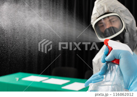 Disinfection workers check whether spraying equipment on various surfaces is working. 116862012