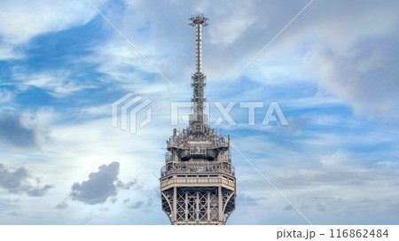 Top of Eiffel Tower in Paris shot against a blue sky. Eiffel Tower, a Parisian landmark, is built for the 1889 World Exposition, it stands as a symbol of France 116862484