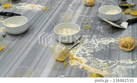 Table full of messy ingredients while baking. Creative mess in the kitchen after cooking, 116862510