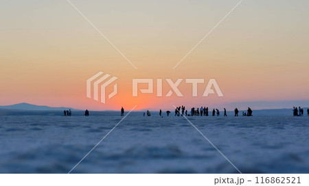 Unidentified people walking on the Lake Tuz, Tuz Golu, the Salt Lake in Ankara, Turkey. Salt lake is drying and getting smaller due to global warming. Climate change concept 116862521