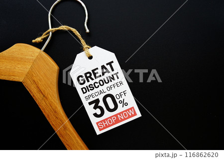 Great Discount 30% Special Offer on price tag with wooden clothes hanger top view on black background 116862620