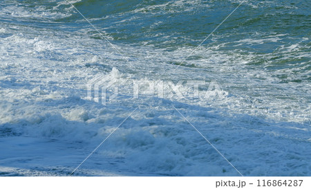 Beach Is Covered With Pebbles. Small Sea Waves. Waves Crashing On A Beach. Still. Beach Is Covered With Pebbles. Small Sea Waves. Waves Crashing On A Beach. Still. 116864287