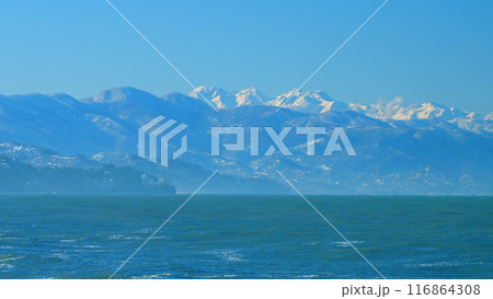 Snow-Capped Mountain Range Against Blue Sky. Rising Temperatures Change The Weather. Real time. 116864308