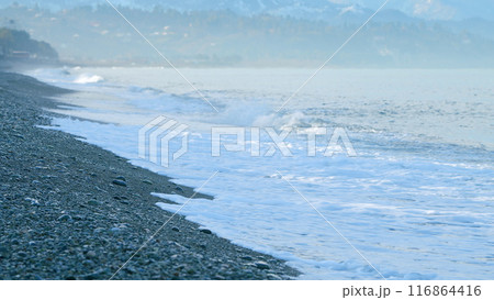 Gorgeous Waterside Bank. Sea Water Waves Are Crashing On The Pebble Beach At Sunrise. Static View. Gorgeous Waterside Bank. Sea Water Waves Are Crashing On The Pebble Beach At Sunrise. Static View. 116864416
