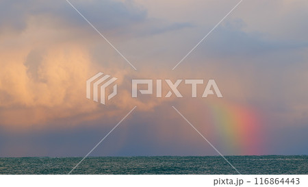 Arc Of Rainbow With Sunset Orange Clouds Tropical Sky. Rain And Thunderstorms. Static view. Arc Of Rainbow With Sunset Orange Clouds Tropical Sky. Rain And Thunderstorms. Static view. 116864443