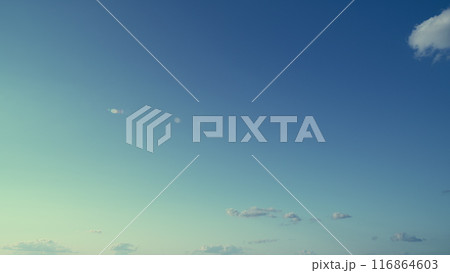 Summer Or Spring Sky With Cloudscape Scattered Across Horizon. Clear Blue Sky And White Clouds Summer Background. Summer Or Spring Sky With Cloudscape Scattered Across Horizon. Clear Blue Sky And White Clouds Summer Background. 116864603