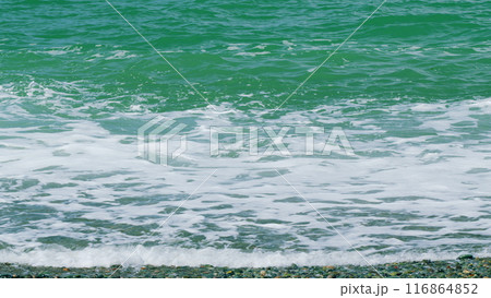 Azure Pure Turquoise Ocean On A Warm Summer Day. Sea Blue Water Waves Foam. Slow motion. 116864852