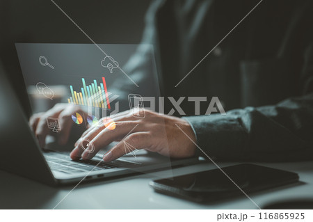 Person typing on a laptop with various data charts and icons. It symbolizes the use of digital technology for data analysis, communication, and cloud computing in a modern work environment. 116865925