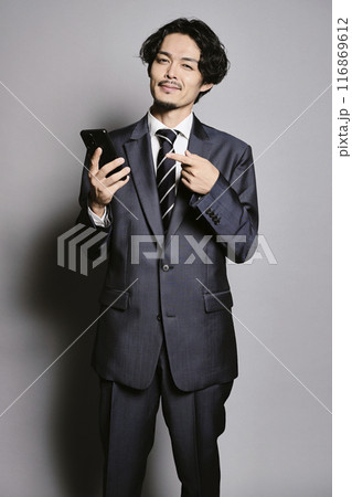 グレーバックでスマホを見ている男性 116869612