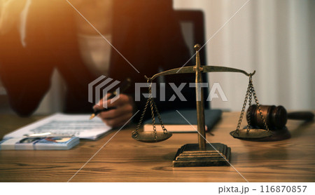 Judge gavel with Justice lawyers having team meeting at law firm background. Concepts of Law and Legal services. 116870857