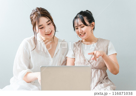 家で友達と一緒にノートパソコンを使う女性・友達・ママ友・仲間 116871038