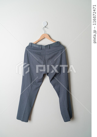trousers or long pants hanging on wall trousers or long pants hanging on wall 116872471