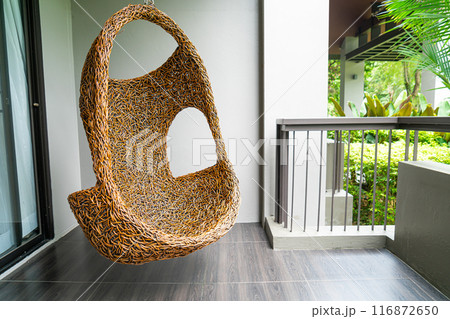 empty wicker swing on blacony 116872650