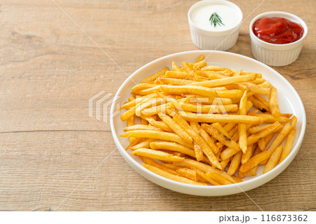 French fries with sour cream and ketchup 116873362