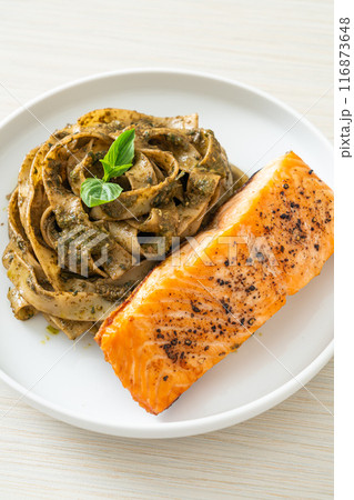 pesto fettuccine spaghetti pasta with grilled salmon fillet pesto fettuccine spaghetti pasta with grilled salmon fillet 116873648