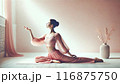 おしゃれなインテリアでリラックスするヨガポーズの女性 116875750