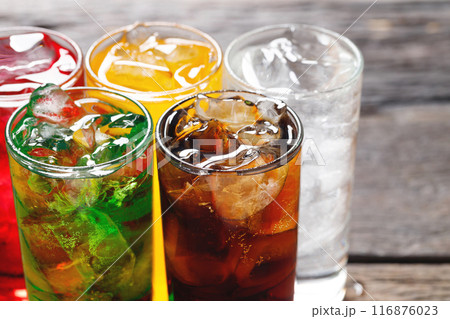 Soft drinks and fruit juice mixed with soda high in sugar have a negative effect on physical health 116876023