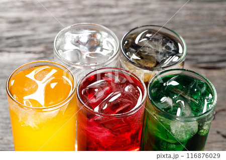 Soft drinks and fruit juice mixed with soda high in sugar have a negative effect on physical health 116876029