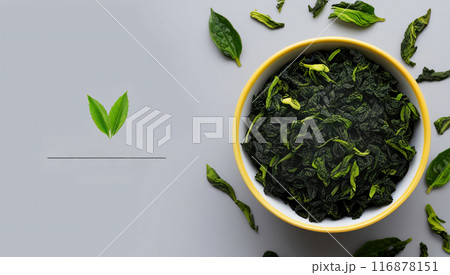Green tea leaves light gray background 116878151