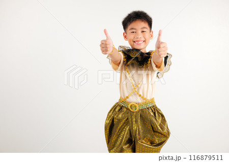 Portrait Thailand kid boy smiling traditional Thai dress costume makes thumbs up OK sign, symbolizing agreement, studio isolated white background, primary child radiates positivity and satisfaction Portrait Thailand kid boy smiling traditional Thai dress costume makes thumbs up OK sign, symbolizing agreement, studio isolated white background, primary child radiates positivity and satisfaction 116879511