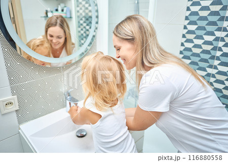 mom teaches child hands washing 116880558