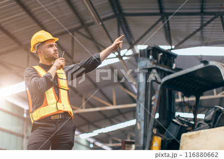 smart confident young caucasian forman radio command control operate work loading cargo warehouse in factory smart confident young caucasian forman radio command control operate work loading cargo warehouse in factory 116880662