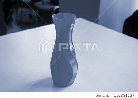 Object in the form of a vase printed on a 3D printer. Three-dimensional model printed on a 3D printer from molten plastic. Concept 3D Printing. FDM 3D Printing technology Object in the form of a vase printed on a 3D printer. Three-dimensional model printed on a 3D printer from molten plastic. Concept 3D Printing. FDM 3D Printing technology 116881337