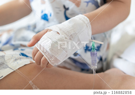 Close up child hand with saline IV solution in hospital Close up child hand with saline IV solution in hospital 116882858