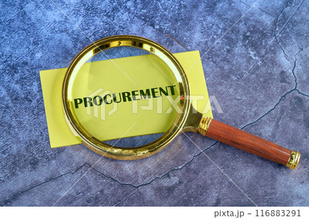 Concept of procurement. PROCUREMENT appeared through a magnifying glass on yellow paper on an abstract background Concept of procurement. PROCUREMENT appeared through a magnifying glass on yellow paper on an abstract background 116883291