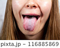 Female tongue. Close-up Of A Woman's Face Showing Her Clean Tongue 116885869