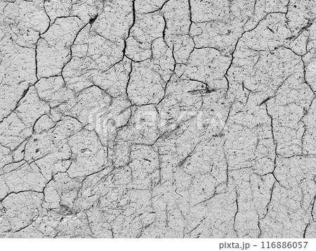 Dry cracked earth surface revealing patterns of drought conditions in rural landscape 116886057