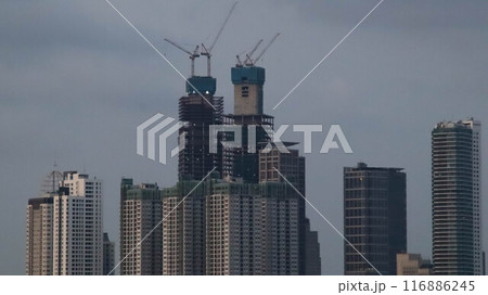 Photo of skyscraper high rise building construction in the middle of the city. Photo of skyscraper high rise building construction in the middle of the city. 116886245