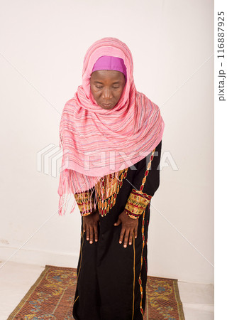 Beautiful young woman praying on white background 116887925