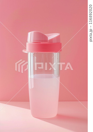 A pink bottle with a pink lid and a clear plastic container inside 116892020