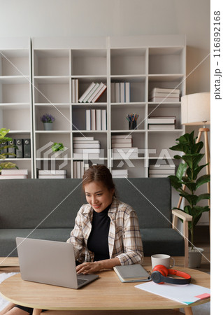 woman meticulously plans a finance audit, using a computer and calculator to review budget documents and ensure accuracy woman meticulously plans a finance audit, using a computer and calculator to review budget documents and ensure accuracy 116892168