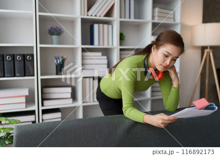 woman plans a finance and budget audit by reviewing organizing Home financial documents woman plans a finance and budget audit by reviewing organizing Home financial documents 116892173