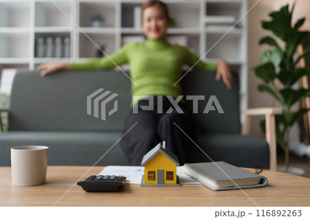 Woman Home Finance Management using calculator, computer and documents Mortgage to plan calculate Woman Home Finance Management using calculator, computer and documents Mortgage to plan calculate 116892263