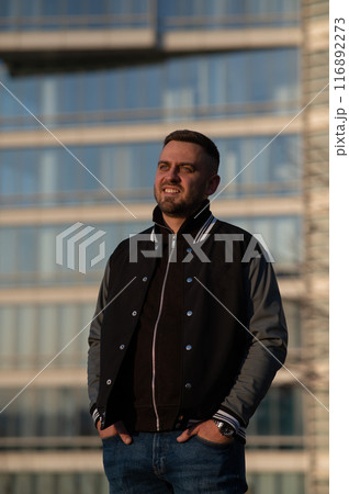 Portrait of a smiling bearded man outdoors at sunset. Portrait of a smiling bearded man outdoors at sunset. 116892273