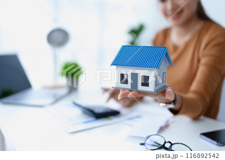 Woman Home Finance Management using calculator, computer and documents Mortgage to plan calculate Woman Home Finance Management using calculator, computer and documents Mortgage to plan calculate 116892542