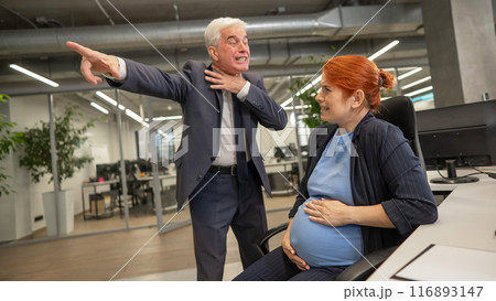Boss fires pregnant subordinate woman from work.  116893147
