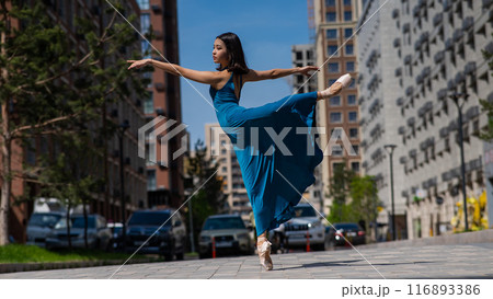 Beautiful Asian ballerina in blue dress dancing outdoors. Urban landscape. Beautiful Asian ballerina in blue dress dancing outdoors. Urban landscape. 116893386