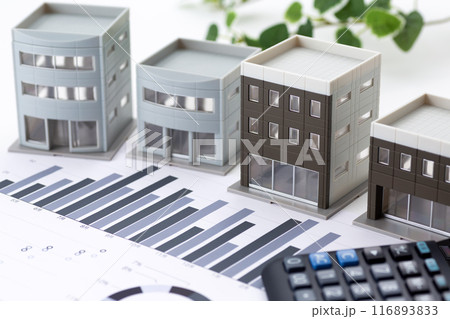 企業のオフィスビルとグラフと電卓 企業のオフィスビルとグラフと電卓 116893833
