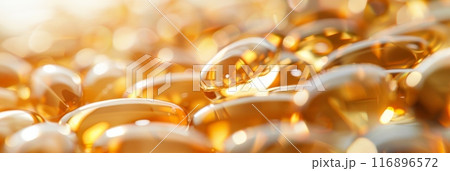 Macro shot of shiny golden capsules with soft focus and warm lighting. Concept of dietary supplements, healthcare, and wellness. 116896572
