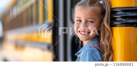 Excited elementary school girl waiting to board the bus with a big smile 116898881