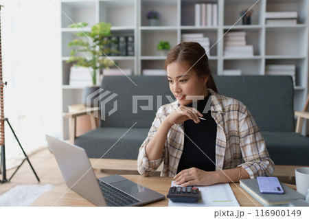 Woman Home Finance Management using calculator, computer and documents Mortgage to plan calculate Woman Home Finance Management using calculator, computer and documents Mortgage to plan calculate 116900149