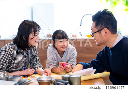 防災についての家族での話し合いで少し楽しそうに笑みを浮かべる娘 116901475