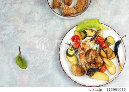 Chicken legs baked with potatoes. Chicken legs baked with potatoes. 116901916
