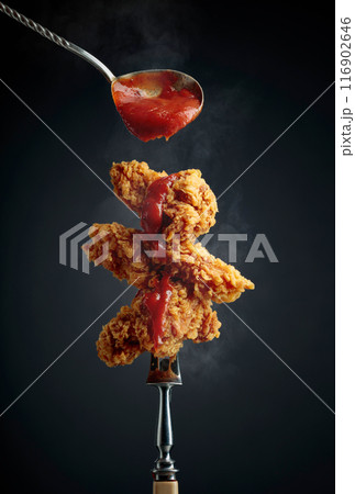 Fried chicken wings with tomato sauce. 116902646