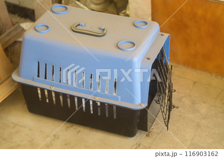 Empty carrier bag for safe transfer of pet cats in black color with the door open. Dusty due to non-use. Devices for tourism, moving pets. 116903162